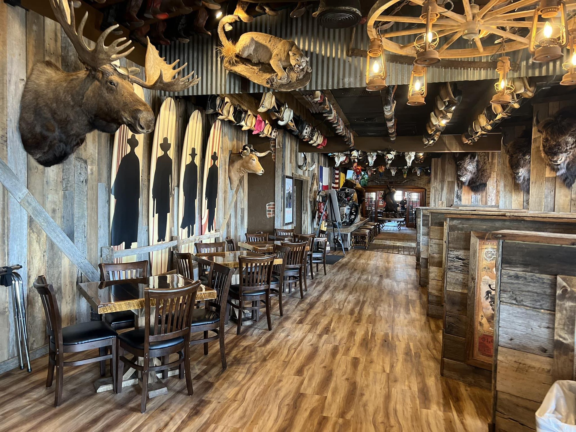 Doc Holliday's — interior with taxidermy and wagon-wheel chandeliers
