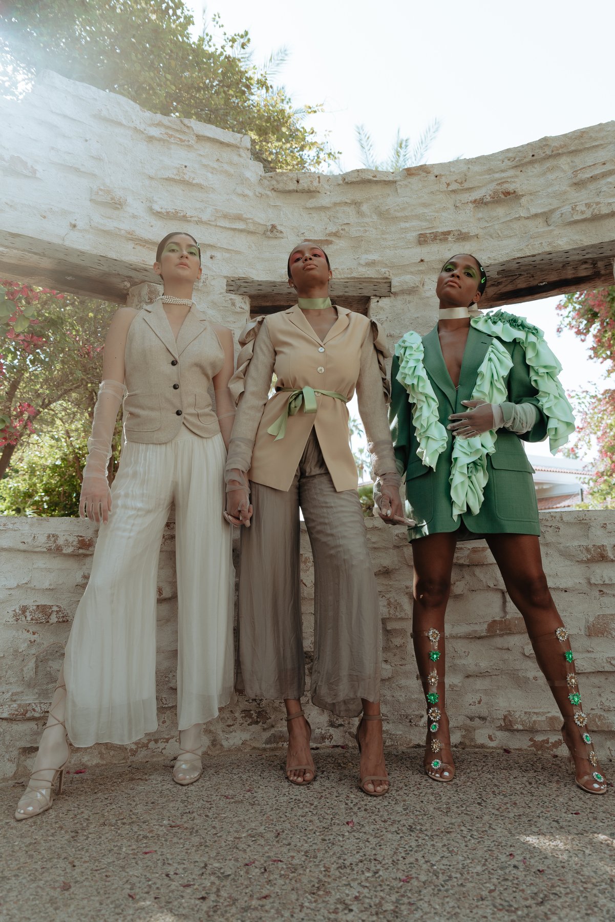 Three models at white stucco archway