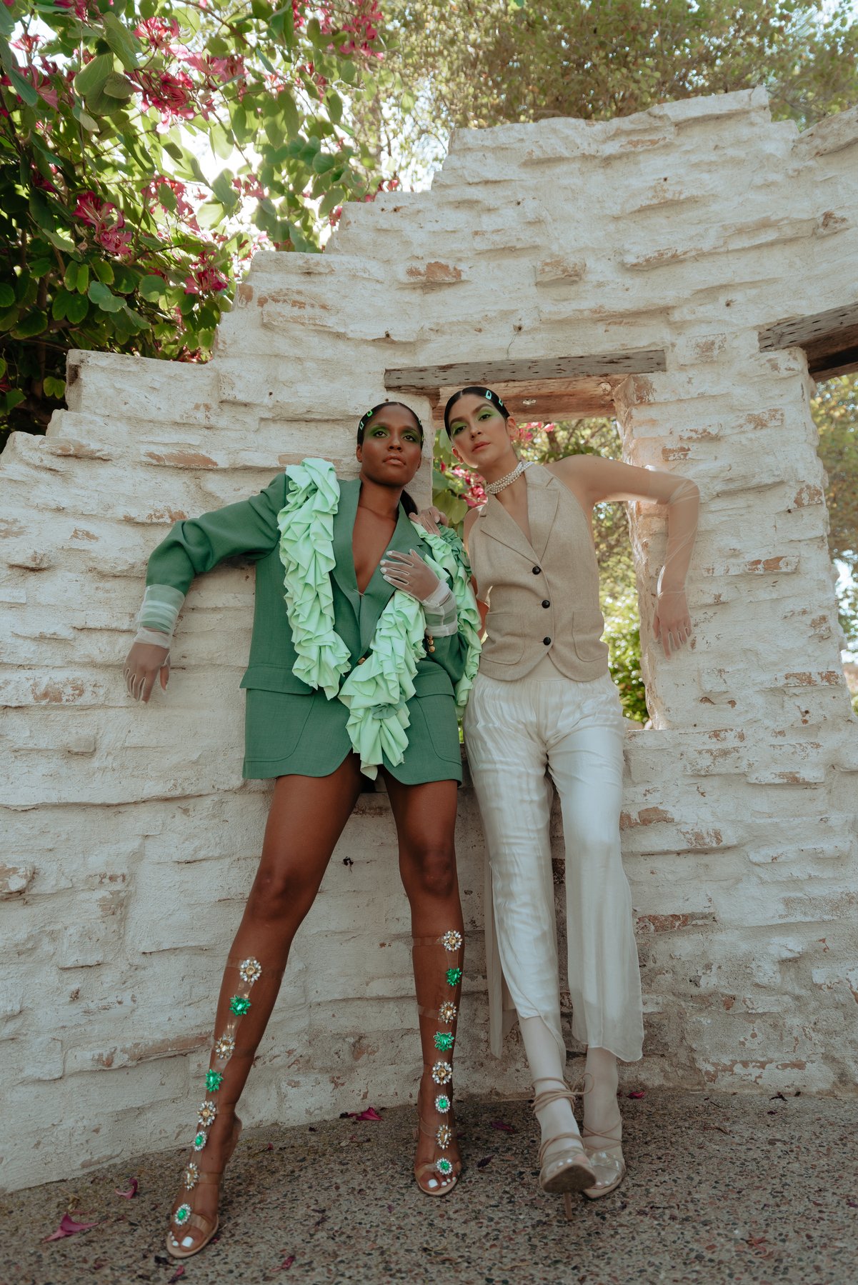 Two models at white stucco archway
